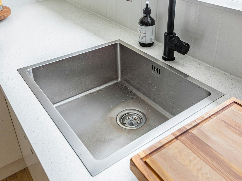 After: Jetted the waste line, replaced the bottle trap and flexible hoses, and added an under-sink grease trap.