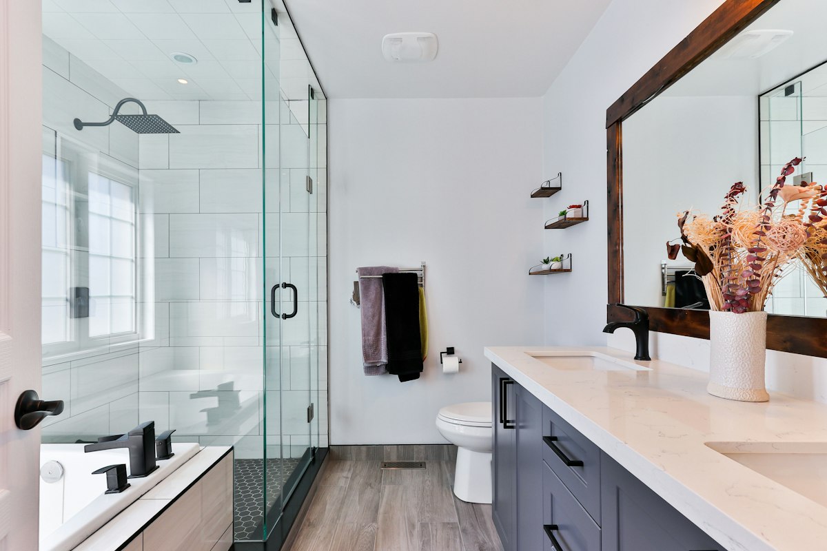 Illustration of a bathroom with shower, basin and tiled wall