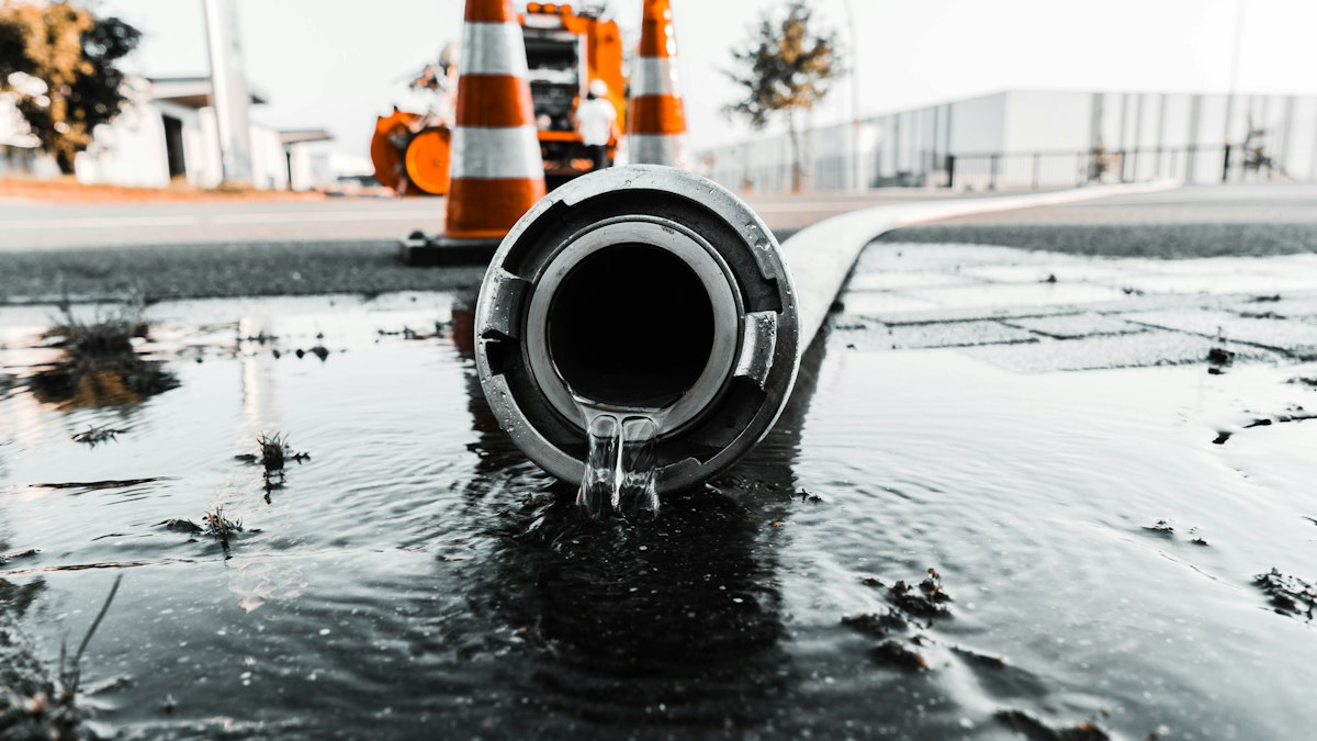 Illustration of a split pipe with water spraying out