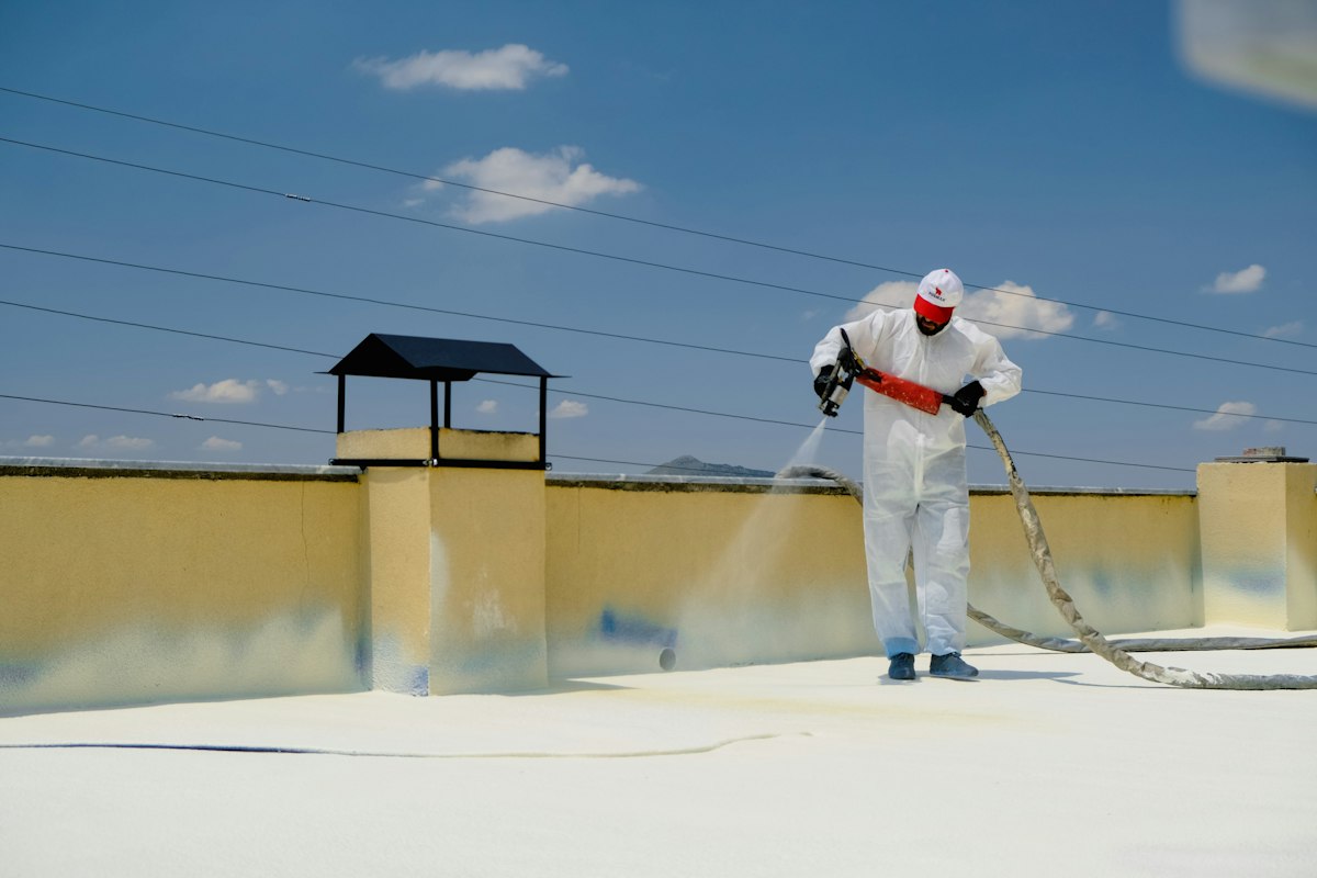 Illustration of a flat roof slab being coated with a waterproofing membrane